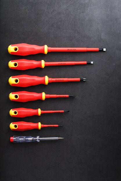 The tool is red screwdrivers in a row on a black background with a free space.