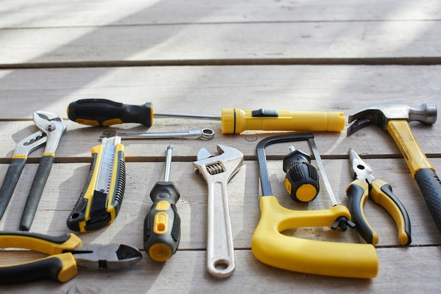 The tool kit is on the table from the wooden planks