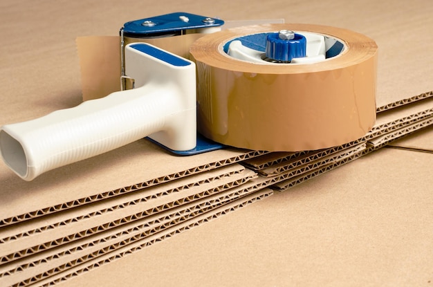 A tool for packaging goods in an online store brown cardboard\
background copy space