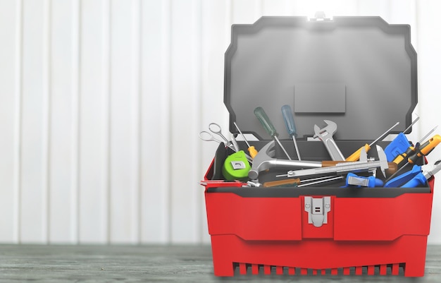 Photo toolbox with various work tools on the desk