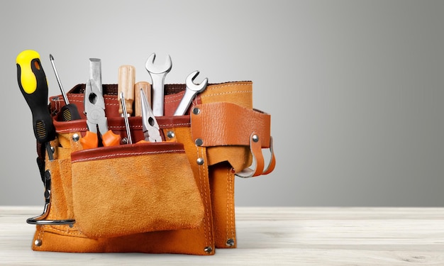 Toolbox With Various Work Tools On Wooden Desk