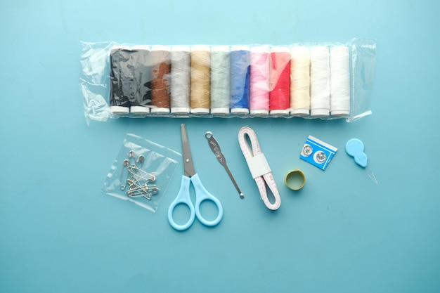 Tools and accessories for sewing on color background