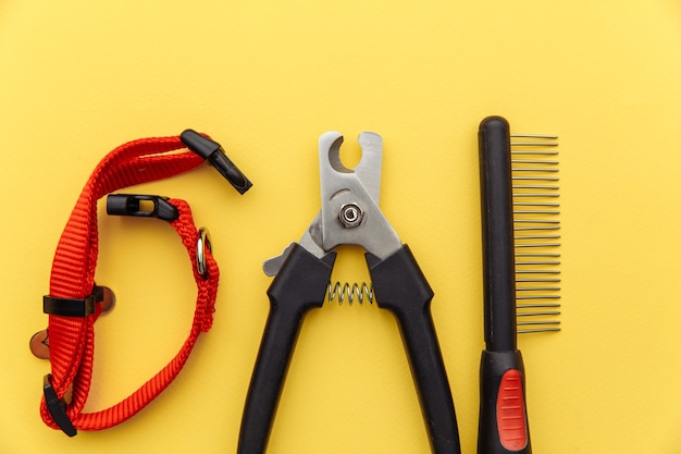 Tools for animal grooming isolated on a yellow background