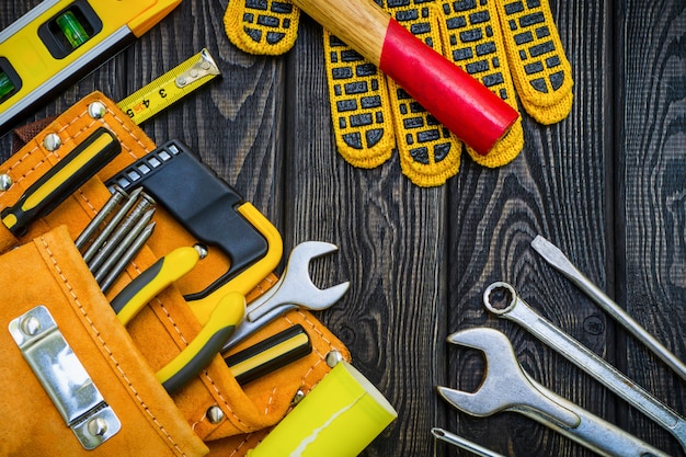 Tools in the bag for carpentry and accessories on black boards