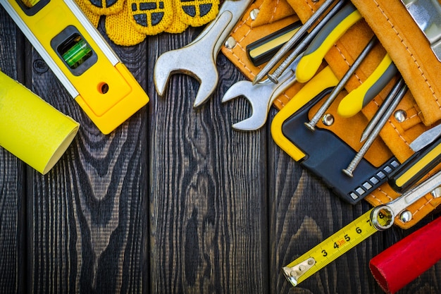 Photo tools in the bag for carpentry and accessories on wooden dark boards