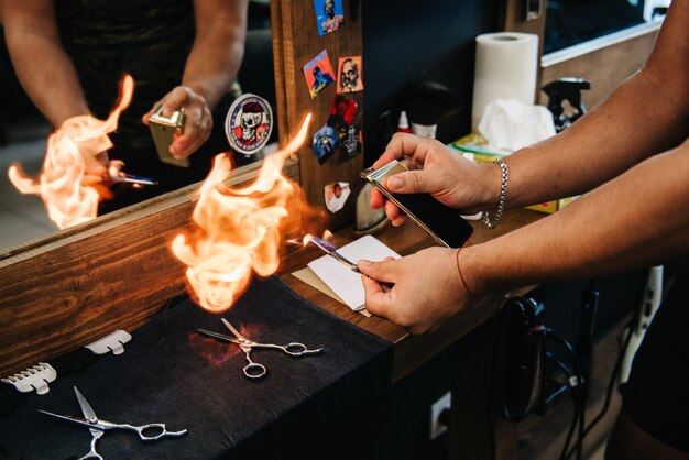 The tools of a Barber on the desktop in front of the mirror