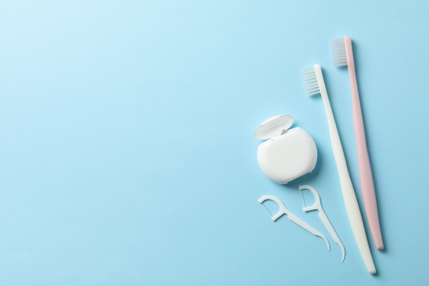 Tools for dental care on blue surface