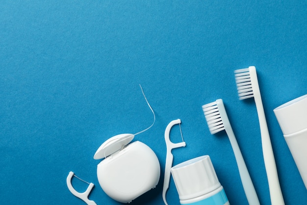 Tools for dental care on blue surface