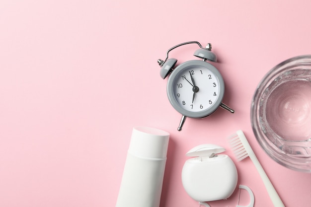 Tools for dental care on pink surface