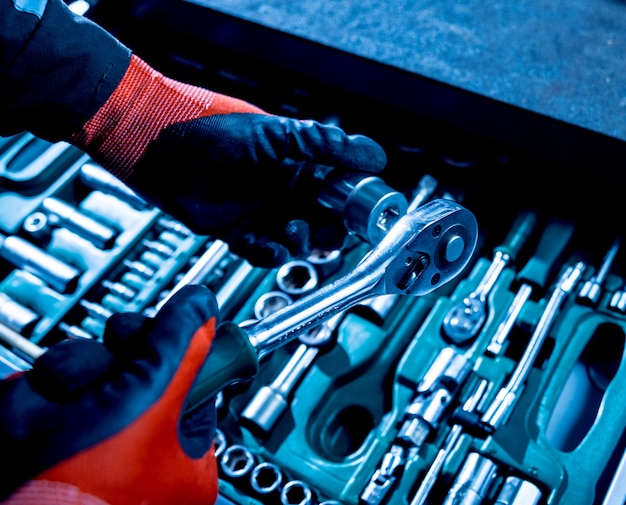 Tools at the hands. Auto repair service