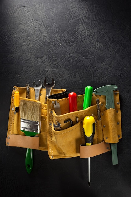 Tools and instruments in belt on black background