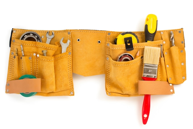 Tools and instruments in belt isolated on white wall