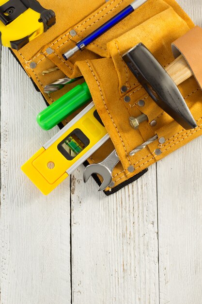 Tools and instruments in belt on wood