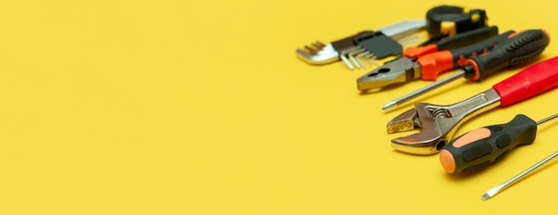 Tools on isolated yellow background panorama