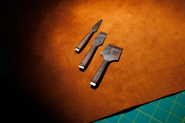 Tools for making leather goods and pieces of brown leather Production of leather products View from above