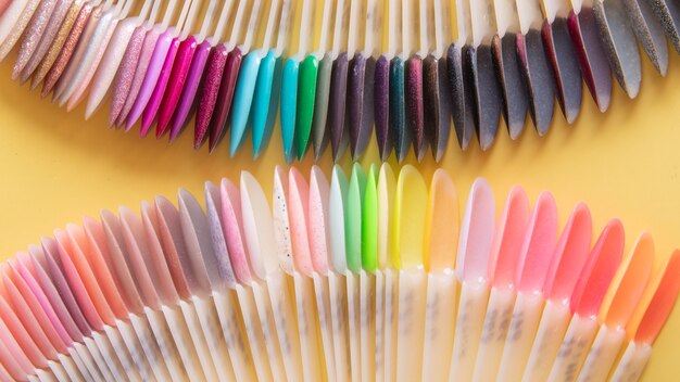 Tools for manicure flat lay on a colored background. Covering nails with gel polish concept