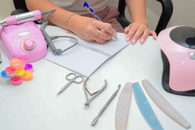 tools for manicure in the salon female hands close up