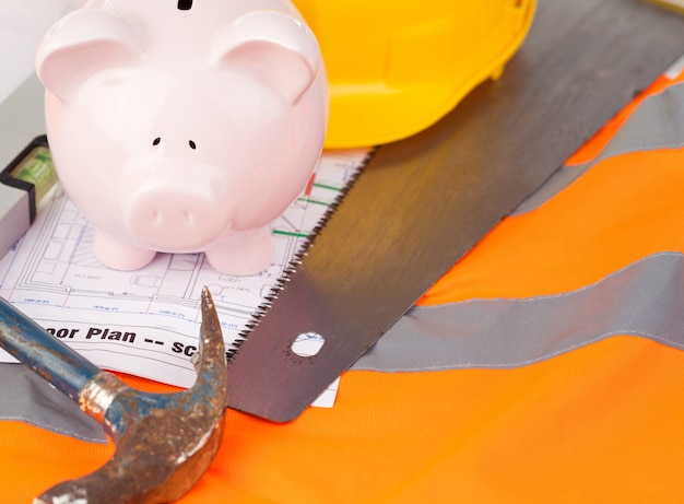 Tools and miniature house on an orange jacket