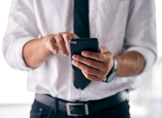 The tools of my success Shot of a businessman using his smartphone to send a text message