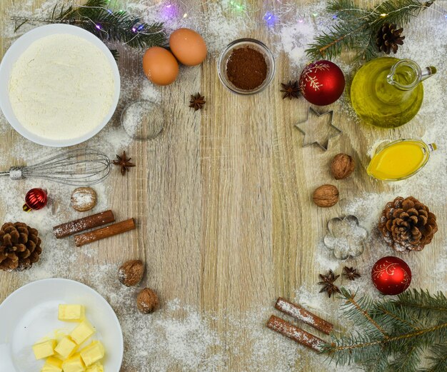 Tools and products for baking homemade gingerbread cookies on a wooden background with empty copy space for text The concept of the holiday celebration and cooking New Year and Christmas card