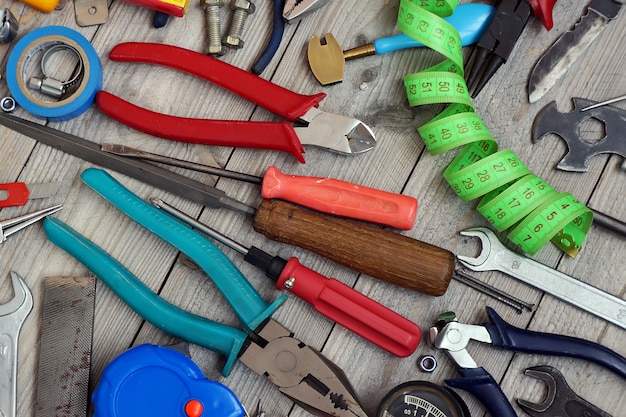 Tools scattered on the wooden floor, top view.                               