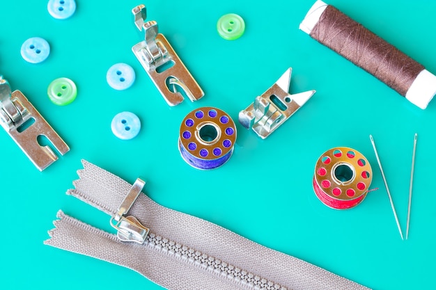 Tools for sewing: threads and  bobbins, needles and zipper