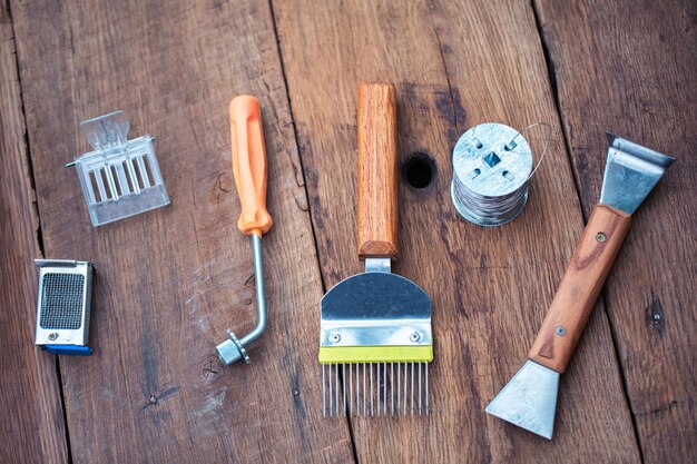 Tools for tending to honeybees on aged wooden surface