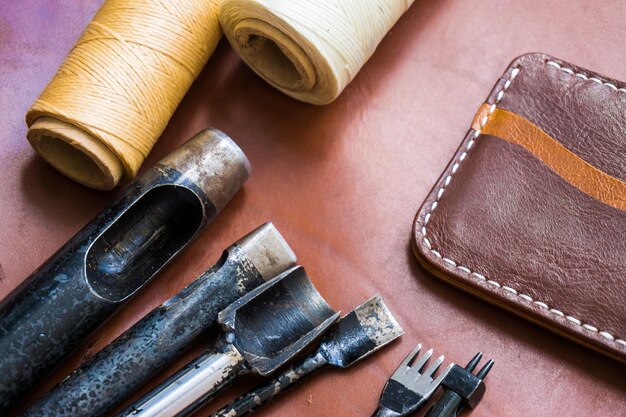 Photo tools with threads and leather on table