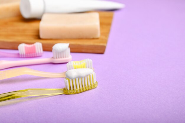 Tooth brushes with paste and soap on color