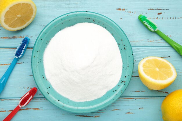 Photo toothbrush and baking soda to clean on blue background