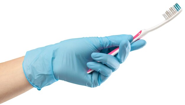 Toothbrush in the gloved hand