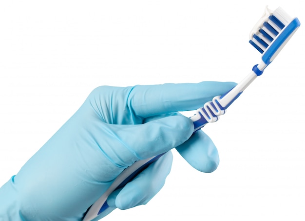 Toothbrush in the gloved hand