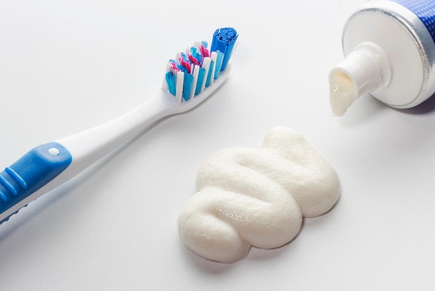 Toothbrush and squeezed toothpaste, concept of oral care.