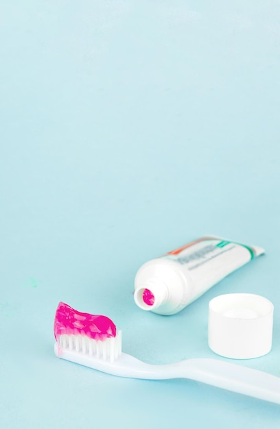 Toothbrush and toothpaste on blurred blue background Oral Care Concept Concept of oral hygiene in the family