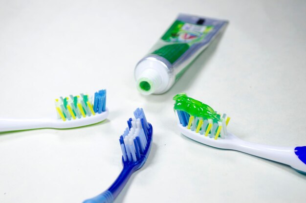 Photo toothbrush with toothpaste in the background