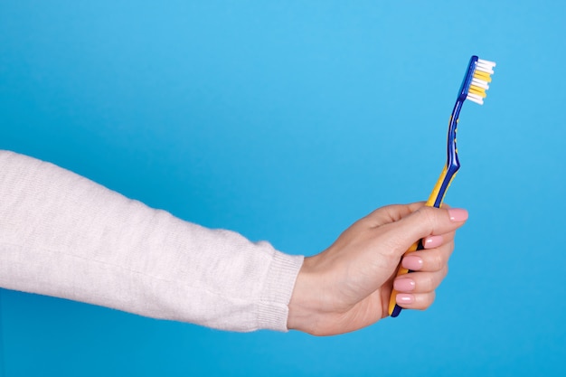 Toothbrush in a woman's hand