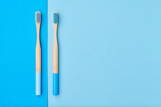 Toothbrushes on blue background top view