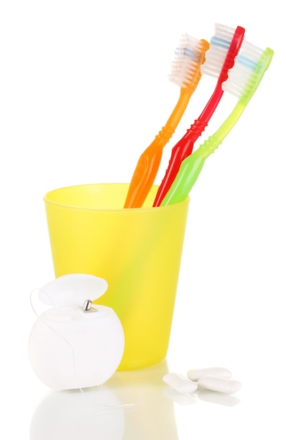 Toothbrushes chewing gum and dental floss isolated on white