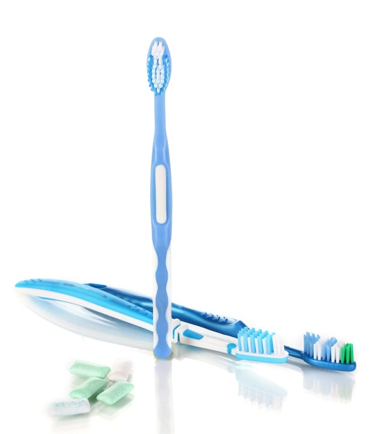 Toothbrushes and chewing gum isolated on white