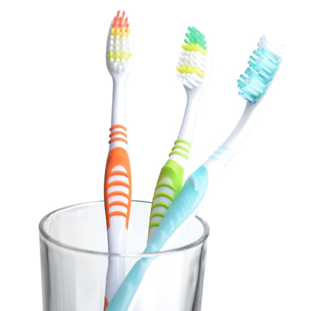 Photo toothbrushes in glass on light grey background