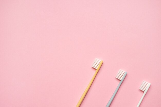 Toothbrushes on pink background