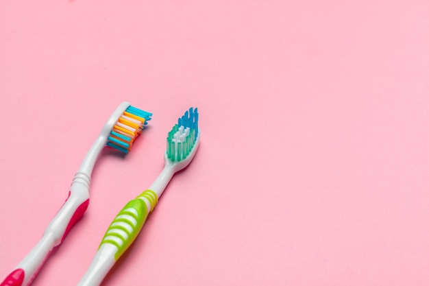 Toothbrushes on pink background