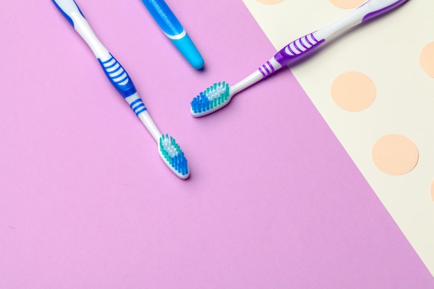 Toothbrushes on pink paper