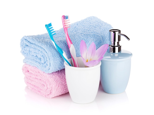 Photo toothbrushes soap two towels and flower