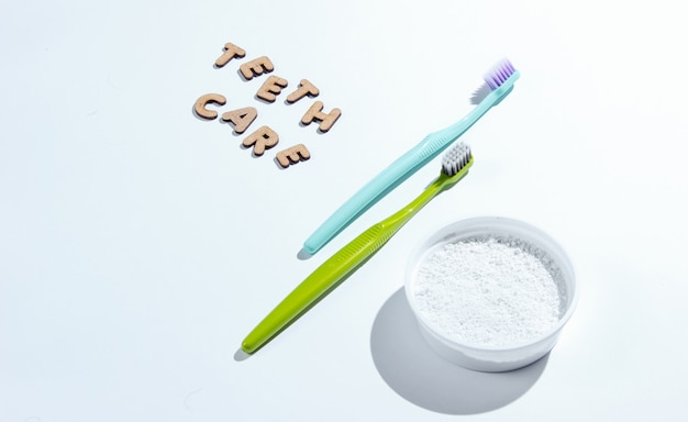 Toothbrushes and teeth powder isolated on white