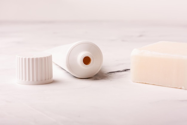 Toothpaste and soap on marble background