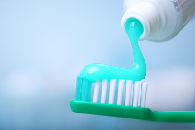 Photo toothpaste squeezed from tube onto brush close up