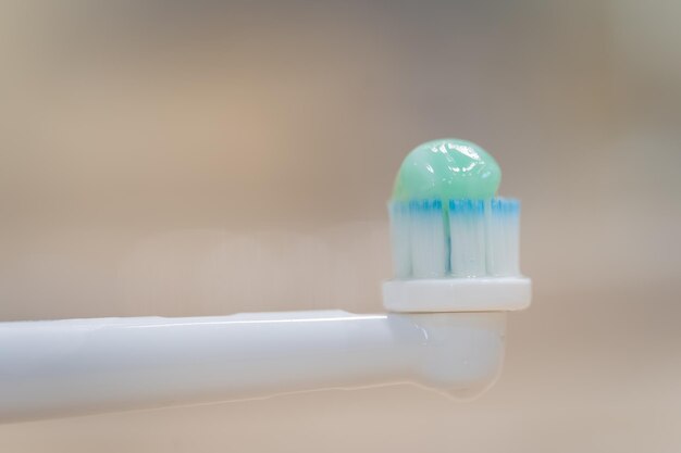 Toothpaste on a toothbrush in a macro shot copyspace