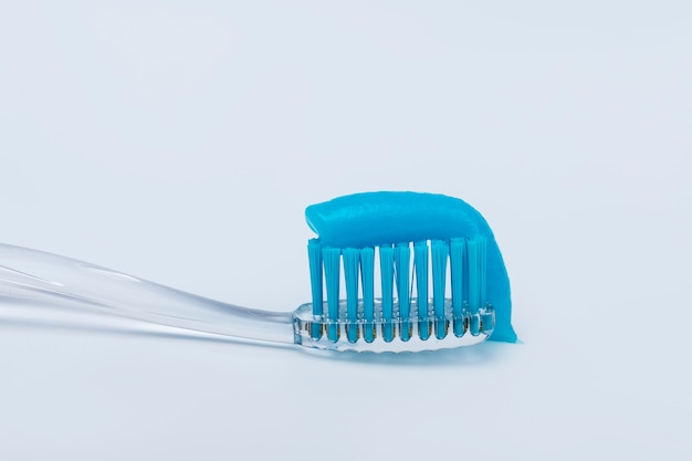 Toothpaste on a toothbrush on a white background.