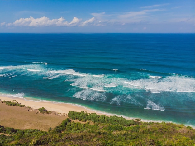 Top aerial view of beauty bali beach. empty paradise beach, blue sea waves in bali island, indonesia. suluban and nyang nyang place